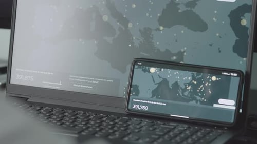 Laptop and Smartphone Displaying Global Data Analysis