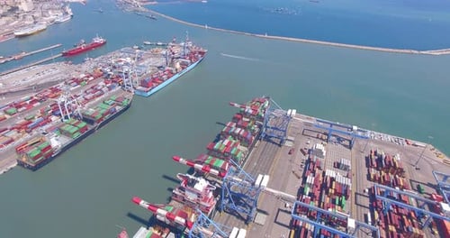 Commercial port with container ships - Top down aerial view.