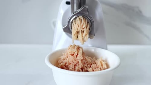 Cooking minced meat in an electric meat grinder from. Kitchen appliances.