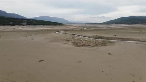 Drone View of a Wet Land with a Channel Through Which Water Flows