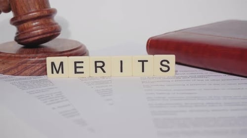 Gavel, Book, and the Word "Merits"