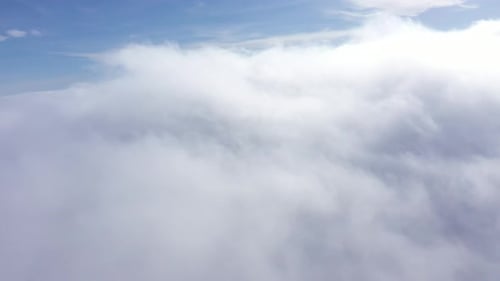 Flying Above the Clouds by Drone. Aerial View