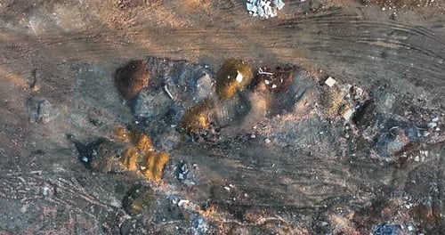 Junk and pollution in empty mine. Metal and waste, environmental pollution theme. Aerial top down bi