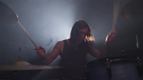 Heavy metal drummer intense performance in slow motion at rock concert