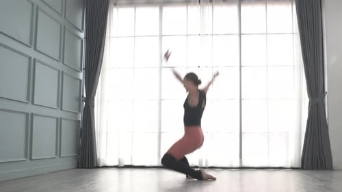 Friends practice ballet dance at studio.