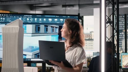 Real Estate Developer Reviewing Architectural Blueprints and Digital 3D Models