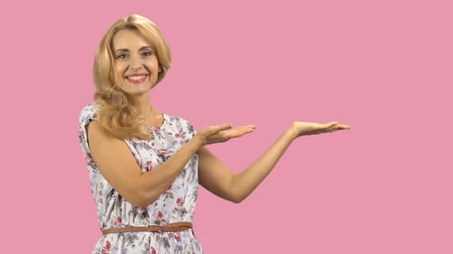 Happy Caucasian Woman Shows Copy Space with Both Hands