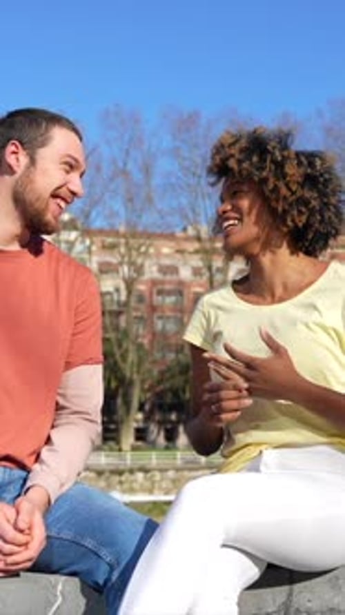 Multiracial friends in the city, lifestyle, listening to music online smiling and dancing