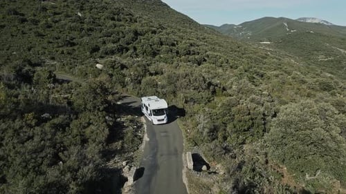 South of France and a large white motorhome travels on a narrow road