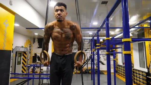 Strong African Athlete Doing Push Ups on Gymnastic Rings at Gym Muscular Afro American Sportsman