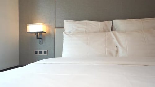 Pan right over hotel made-up bed for two-person