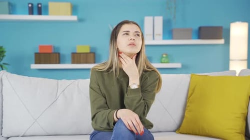 Young girl experiencing sore throat.