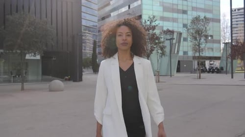 Confident Woman Walking to Work in Urban Setting