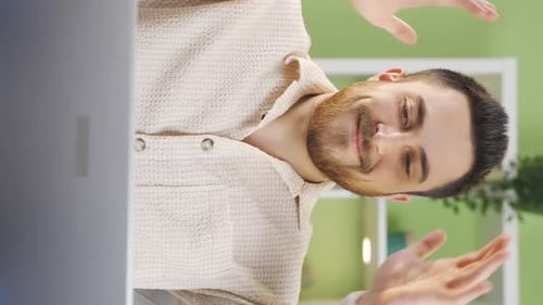 Smiling Young Adult Man in Front of Laptop