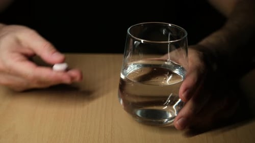 Person Taking Medicine – Close Up Lifestyle Shot