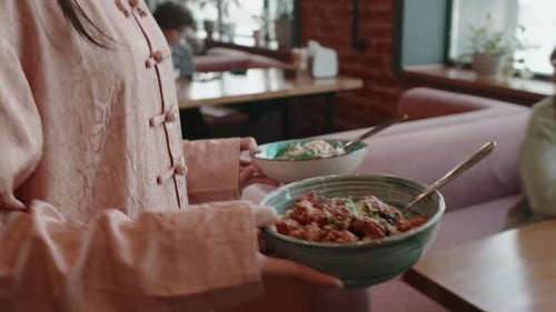 Waitress Bringing Dishes to Table in Cafe, Customers Smiling and Thanking her