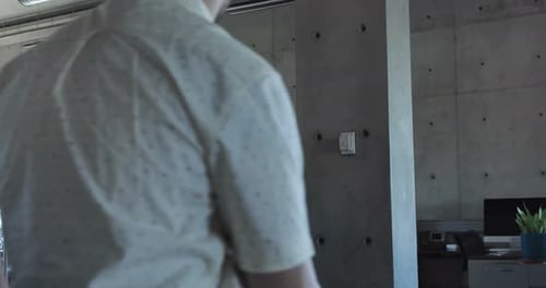 Mature businessman leads multiethnic office meeting at whiteboard planning strategy