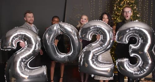 Friends Celebrate New Year Holding 2023 Balloons