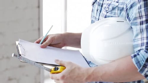 Of Builder with Measuring Tape on Site
