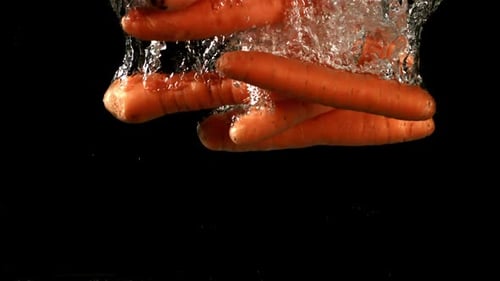 Carrot Falls Under Water Filmed is Slow Motion 1000 Fps