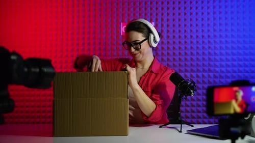 Enthusiastic Woman Unboxing New Product For Online Review