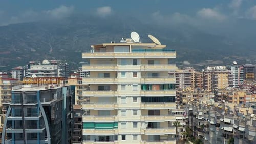 View of the modern city in Turkey near the mountains with clouds on top of it