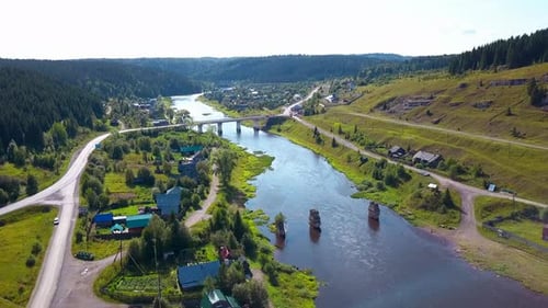 Top view of village and old bridge over river