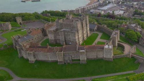 Aerial footage of Dover Castle, showcasing medieval architecture with surrounding green landscapes a