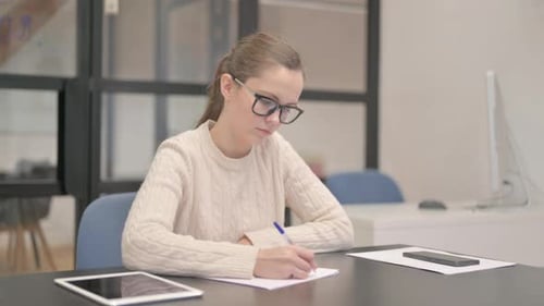 Young Woman Writing a Letter in Office