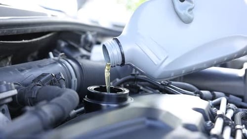 Adding Oil to Car Engine During Maintenance