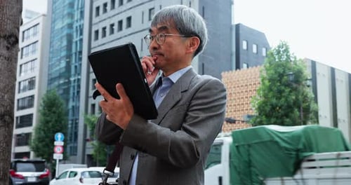 Mature businessman, thinking and tablet in city for planning, brainstorming