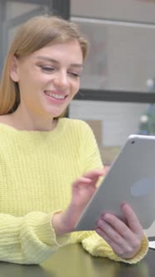 Woman Using a Tablet Device in a Bright Room