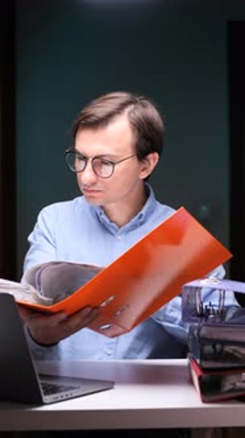 Vertical Video Office Worker Browsing Documents at Night Using Laptop