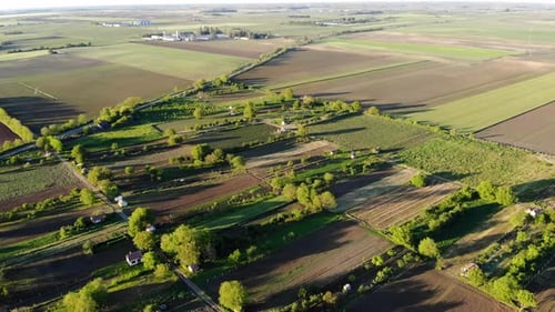 Flying around gardens and fields in Eastern Europe by drone, long shadows