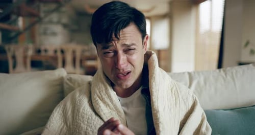 Distressed Man with Cold Using Tissue Indoors