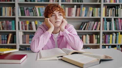 Tired Young Woman Studying in Library