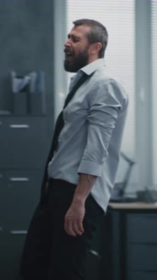 Furious Office Worker Throws Boxes and Papers Off the Shelves Destroys Office Room Screams