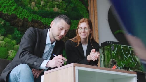 Business People Signing Contract in Green Office