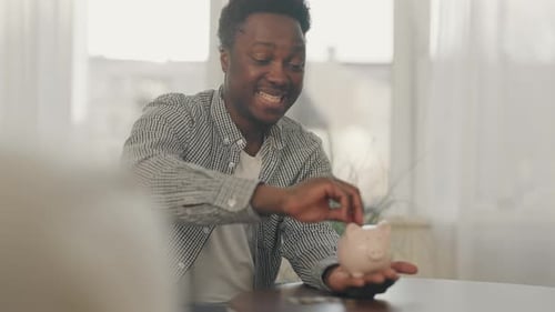 Young Businessman Saving Money for Business Development Man with Piggy Bank African American Male