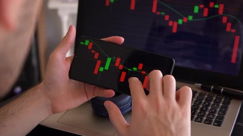 Young Male Investor Shakes Head After Checking Stock Market Bar Chart On Mobile Phone Due To Bearish
