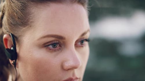 Woman Close Up Wearing Wireless Earbuds Outdoors