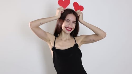 St. Valentine's Day. Beautiful woman with paper hearts on white background