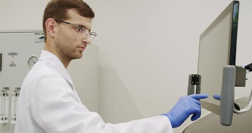 Male Doctor Controlling Analyzing Machine