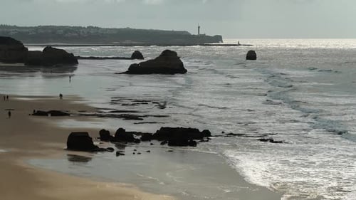 Portuguese Beach Top View of the Rocks and Walking Tourists