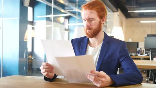 Man Reading Papers in Office