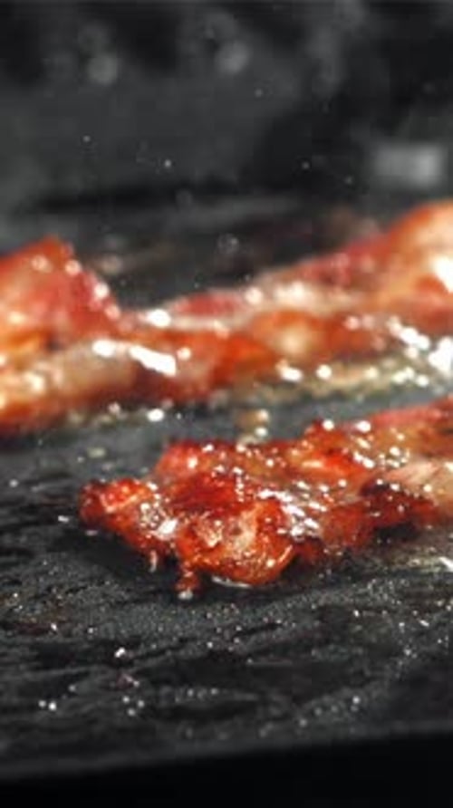 The Bacon is Fried in a Pan with a Splash of Oil Filmed on a Highspeed Camera at 1000 Fps