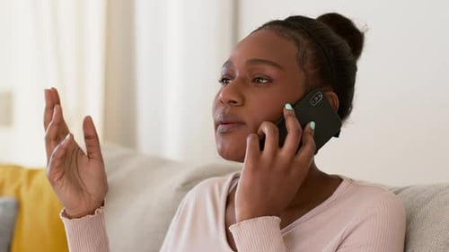 Woman Talks on Phone with Hand Gesture
