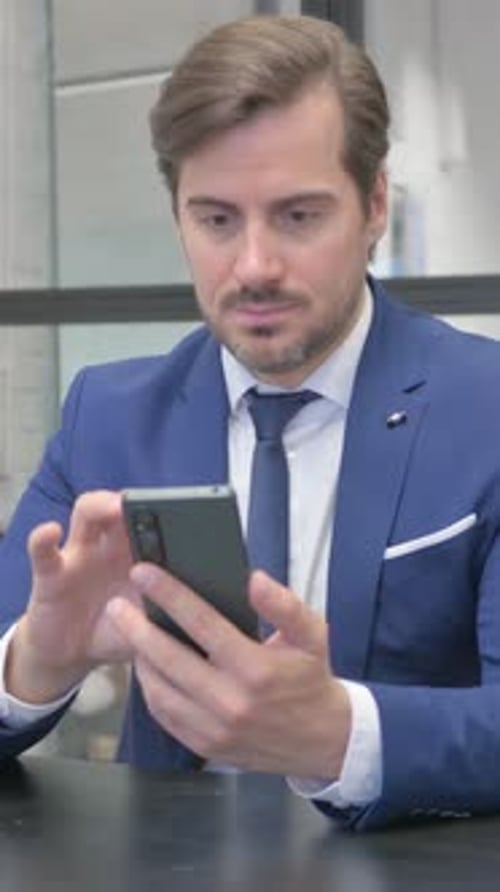 Man in Suit Using Mobile Phone