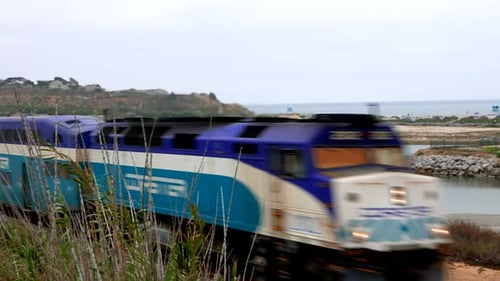Closeup of Train Riding by California Beach and Horizon Aerial