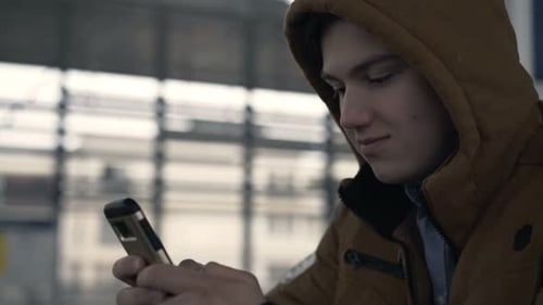 Teenager Surfing Internet, Texting On Smartphone In The City